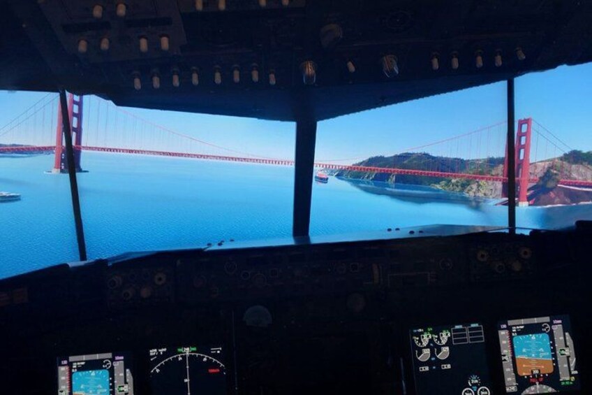 A cockpit view with a large window displaying the Golden Gate Bridge. 2