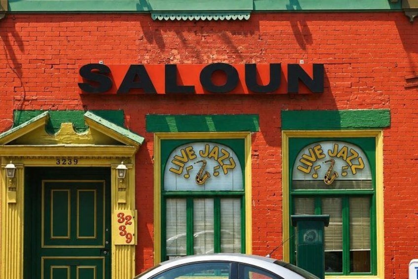 A red building with a green door and windows labeled 'LIVE JAZZ.' 3