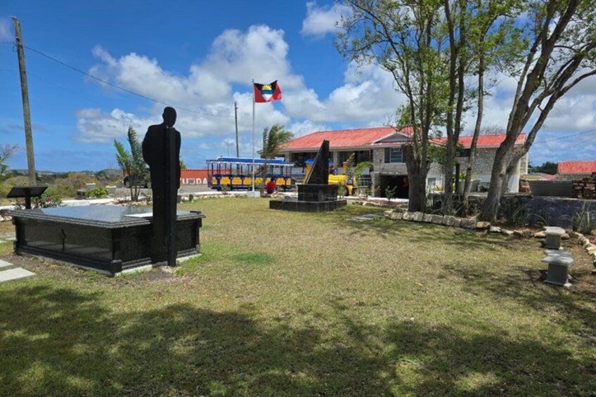 A statue, a flag, a building, and a playground. 1