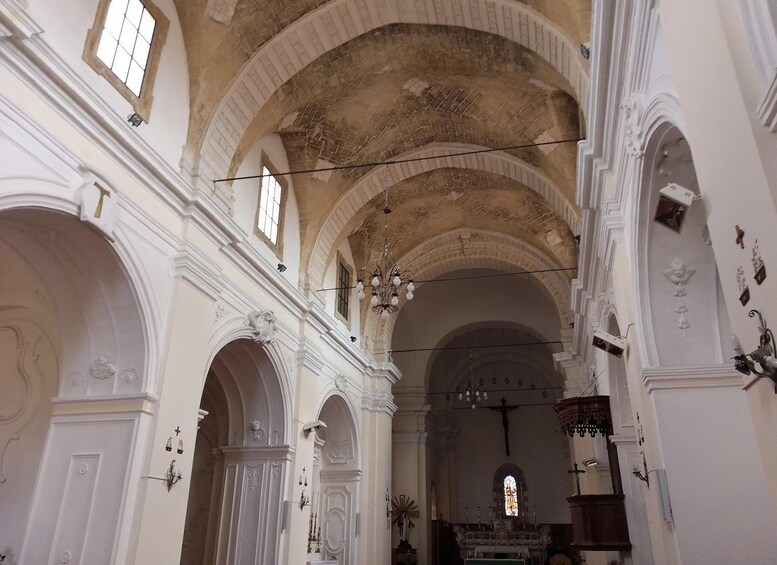An interior of a church with arched ceilings, stained glass windows, and religious statues. 5