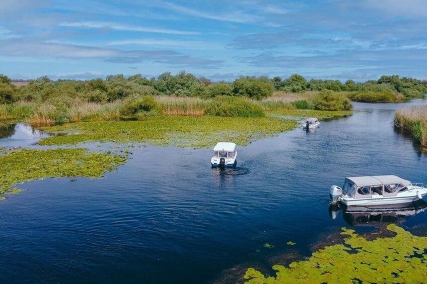 A river with boats and lily pads. 1