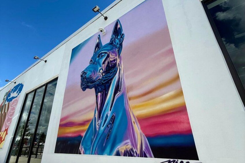 A building with a large mural of a dog. 2