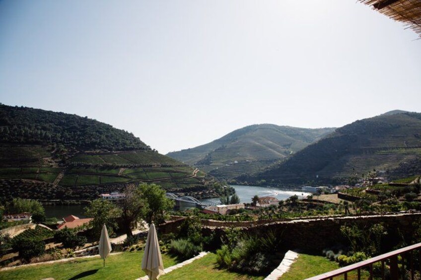 A valley with terraced fields, a river, and a bridge. 4