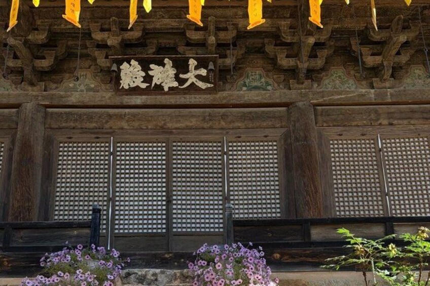 A traditional wooden building with a sign that reads 'Acupuncture Hall'. 5