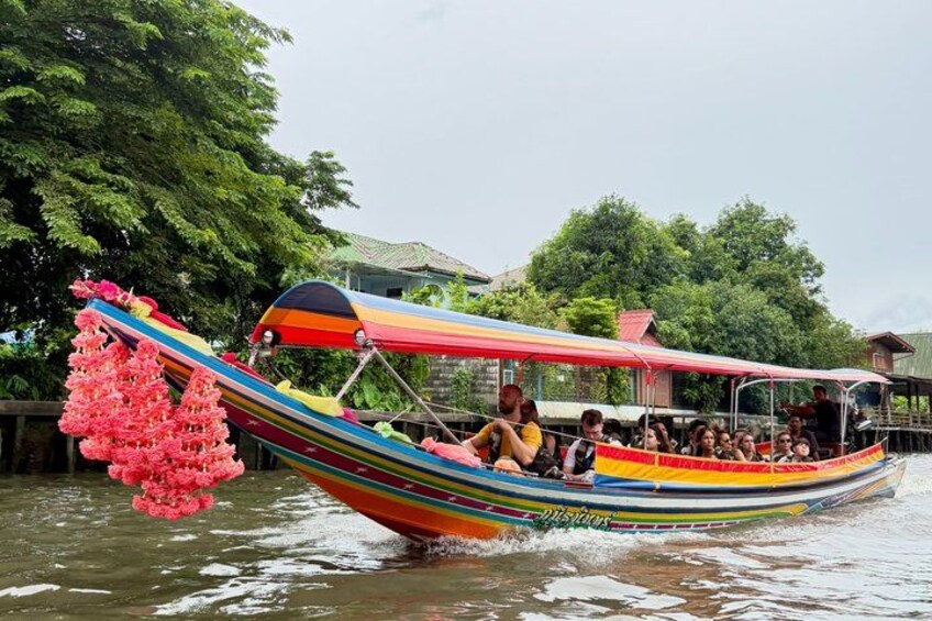 A colorful boat with passengers, floating on water. 5