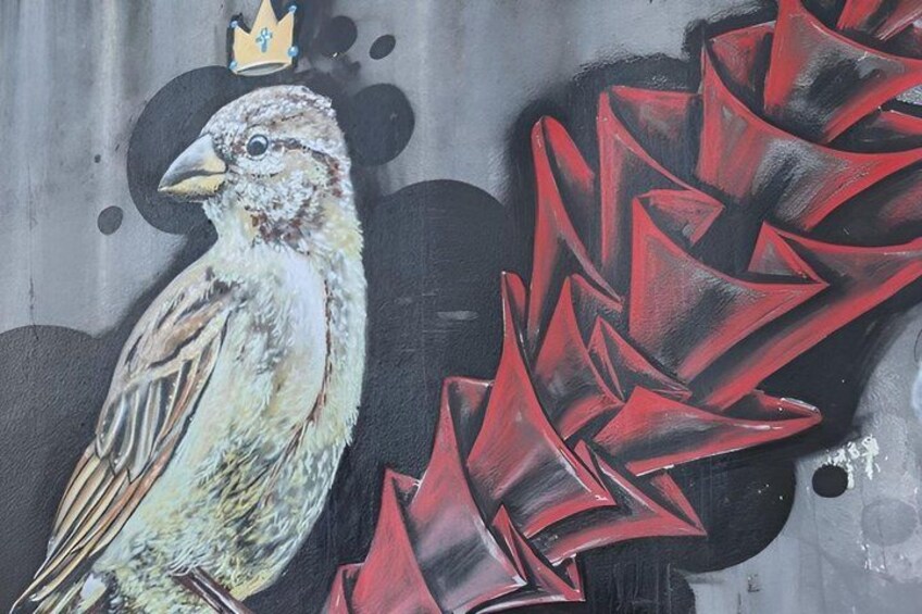 A bird with a crown, red abstract shapes, and a grey background. 3