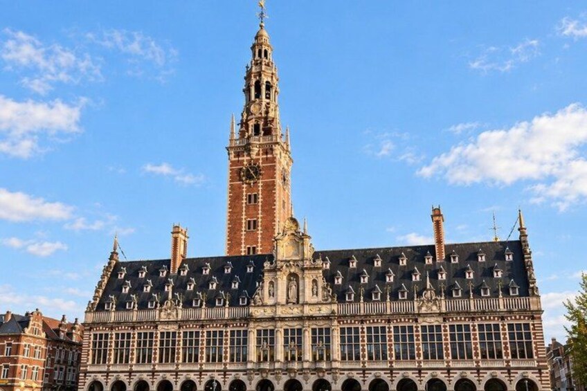 A historic building with a tall tower and a large arched entrance. 4