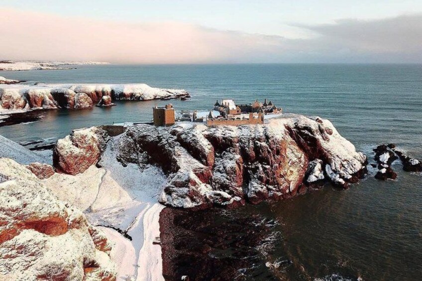 A coastal landscape with rocky formations and a small building on a cliff. 3