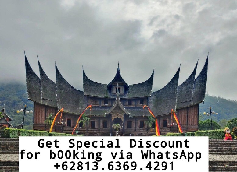 A traditional multi-tiered building with a steeply pitched roof, surrounded by lush greenery and a cloudy sky. 1