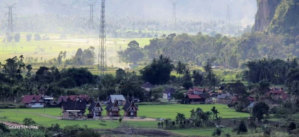 A rural landscape with houses, fields, and power lines. 5