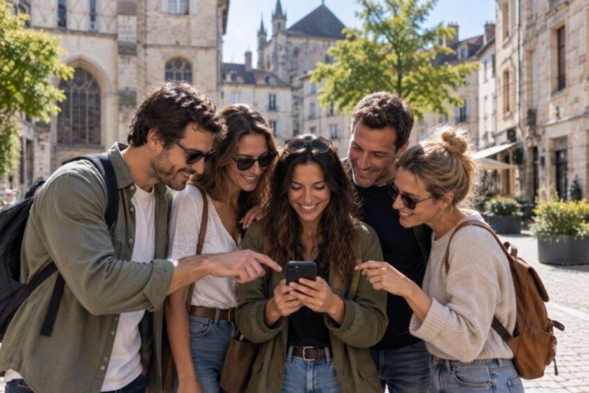 A group of people looking at a smartphone in a historic town square with old buildings. 1