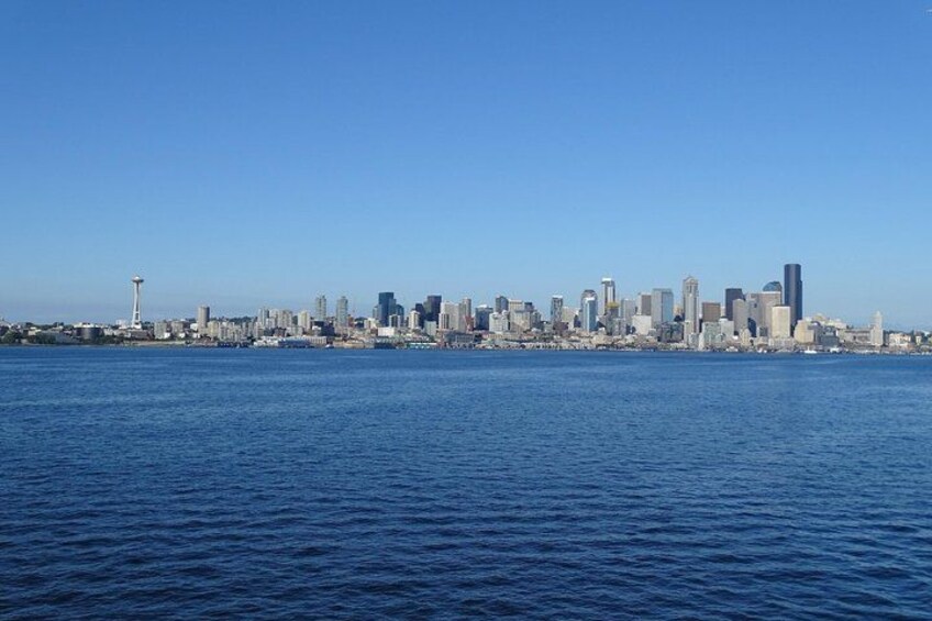 A city skyline across a body of water with a prominent tower. 5