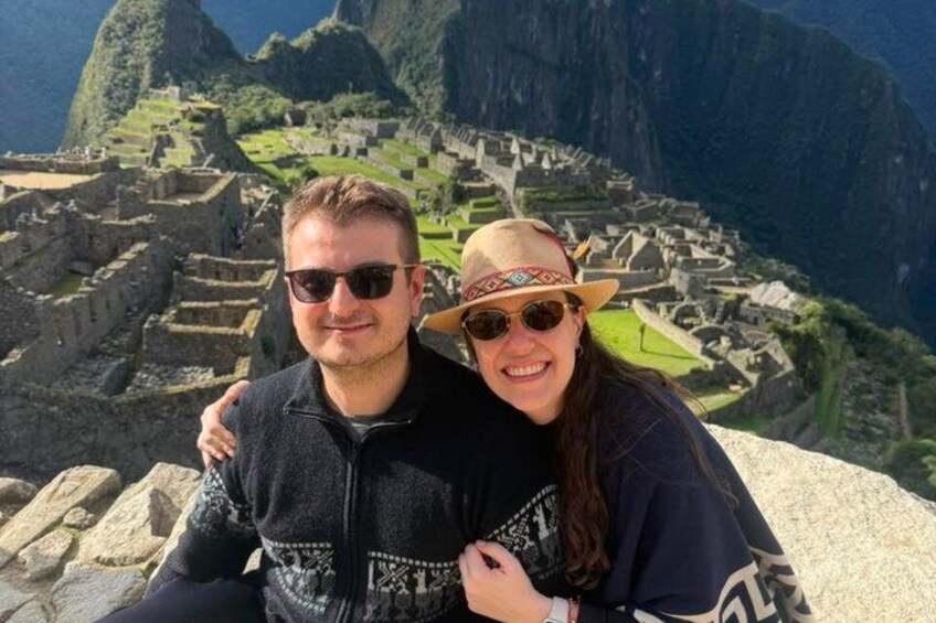 A couple at Machu Picchu with Inca stone ruins in the background. 1