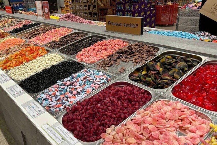 A candy display with various types of sweets in trays. 2