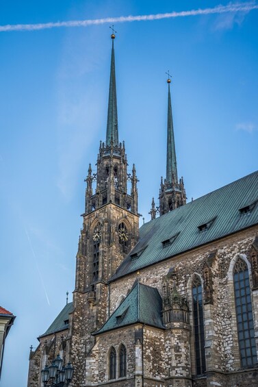 A historic church with two tall spires and a clock tower. 3