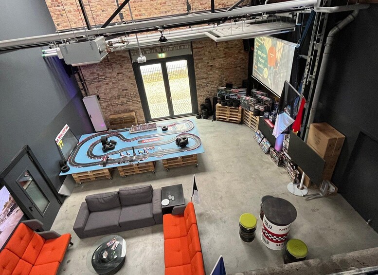 A room with a racing simulator setup, a couch, and a coffee table. 4