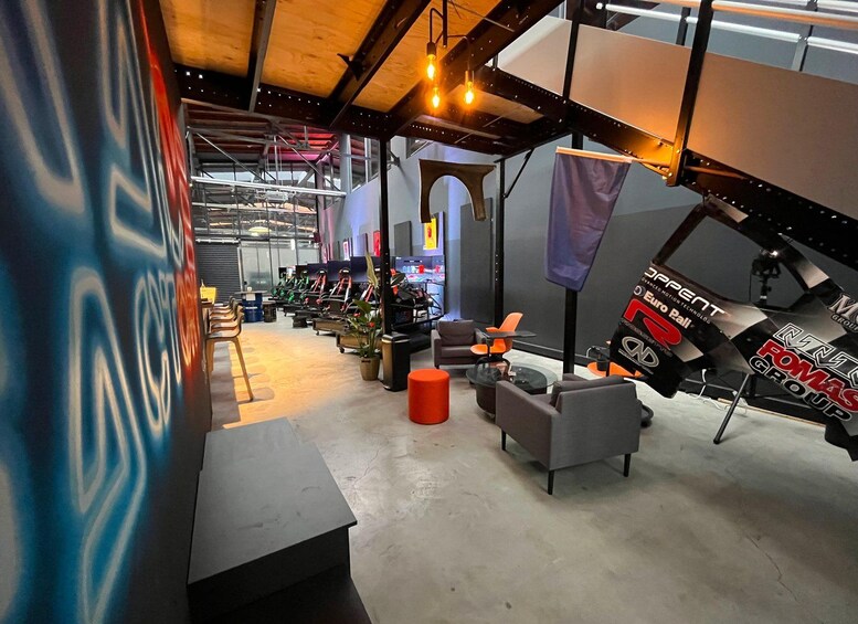 An indoor space with exercise equipment, seating areas, and banners. 2