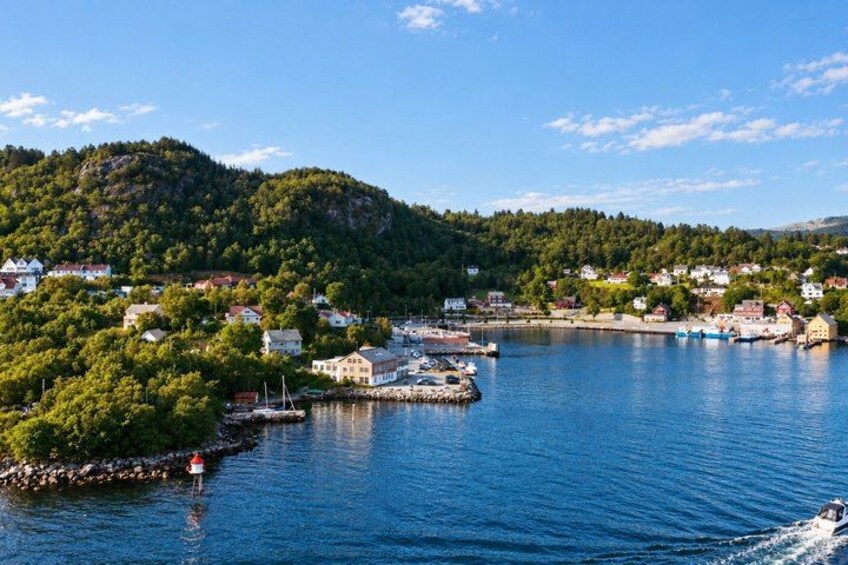A coastal town with houses, a marina, and a hill in the background. 4