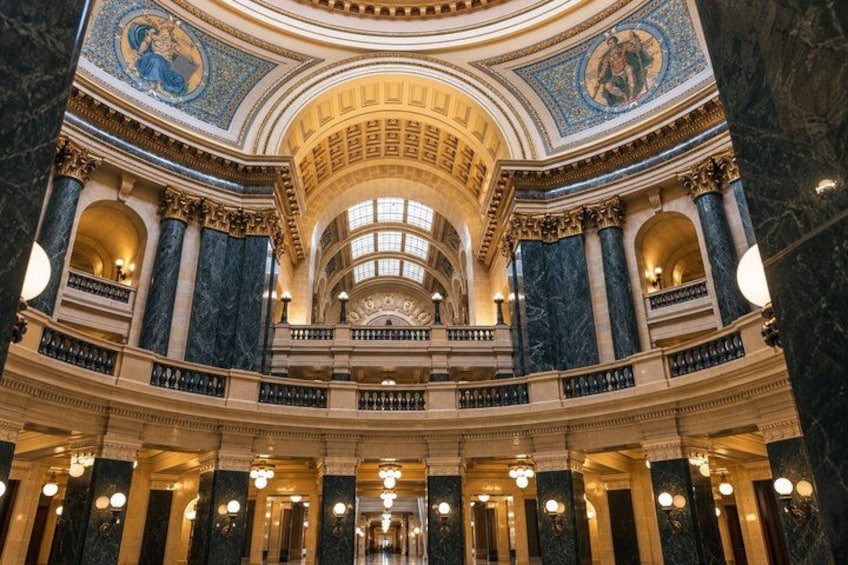 A grand interior with a domed ceiling, marble columns, and ornate decorations. 3