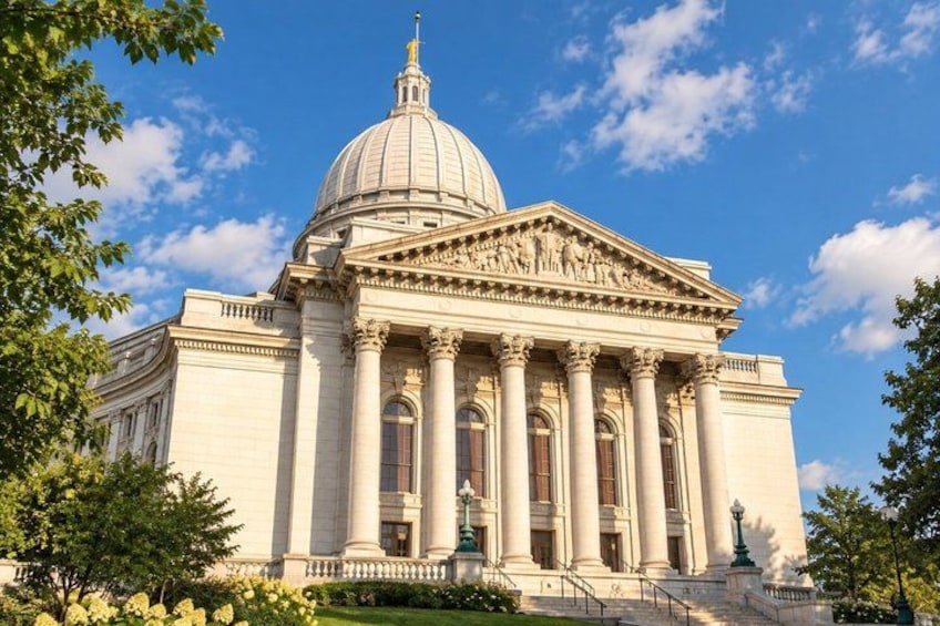 A neoclassical building with a large dome, columns, and a portico. 5