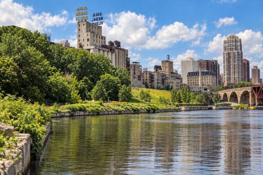 A river with a bridge, a city skyline, and a building with 'BRILL MEDAL' text. 4