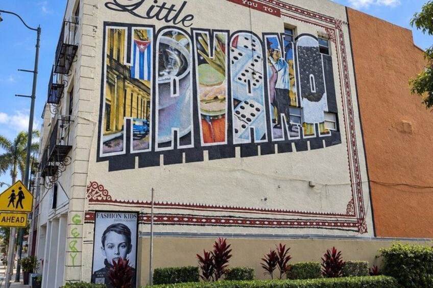 A mural on a building with the words 'Little Havana' and 'Fashion Kids' visible. 2