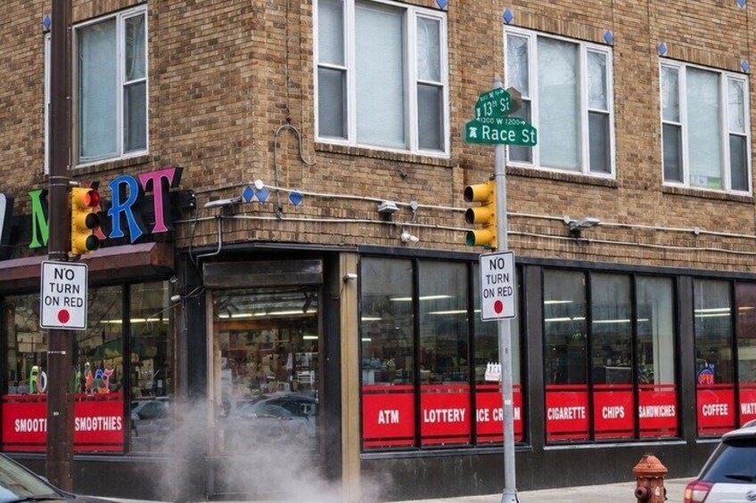 A brick building with a storefront labeled 'NIFT' and a sign for 'Race St.' 4
