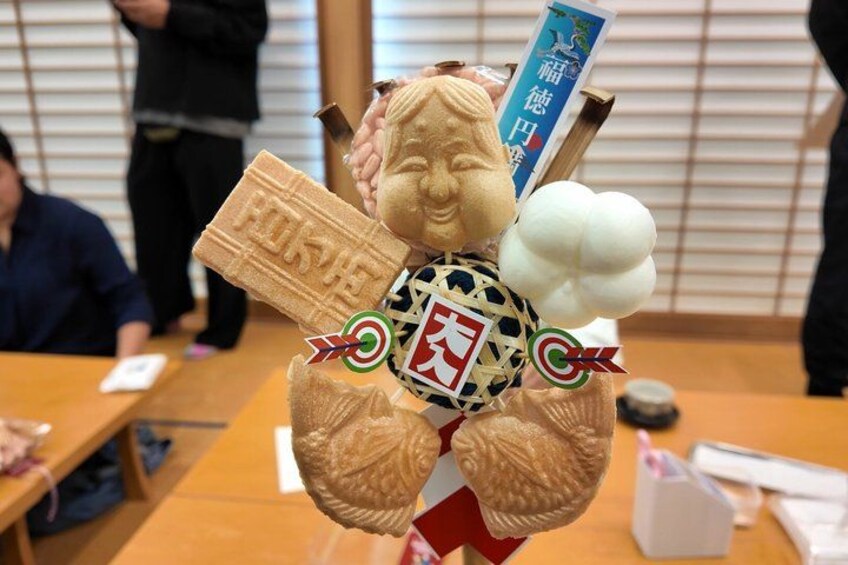 A person holding a large ice cream cone and a chocolate bar. 1