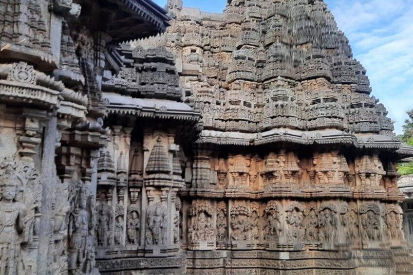 A detailed stone temple with intricate carvings and tiered architecture. 1