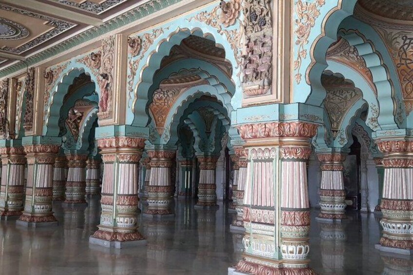A grand hall with ornate arches and columns, featuring intricate designs and patterns. 3