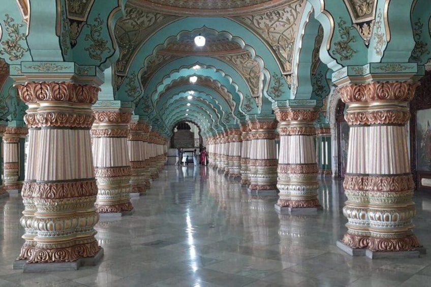 A grand hall with ornate columns and intricate ceiling designs. 2