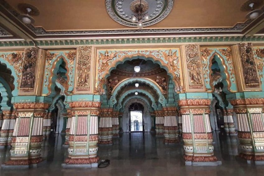 An ornate hall with intricate carvings, arches, and columns. 4