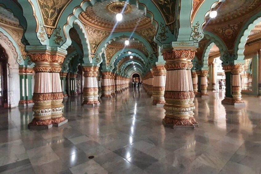 An ornate corridor with elaborate columns and arches. 5