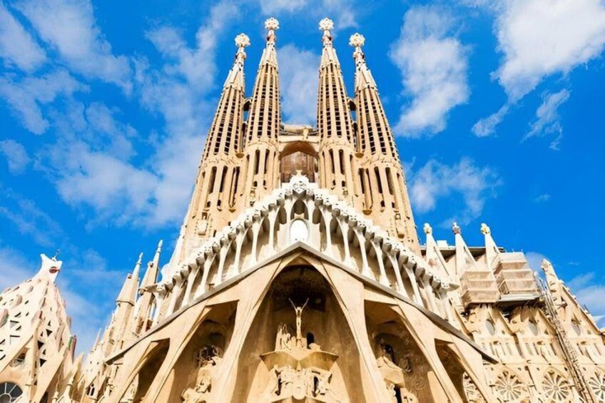 A large, ornate building with a distinctive facade featuring multiple spires and intricate architectural details. 1