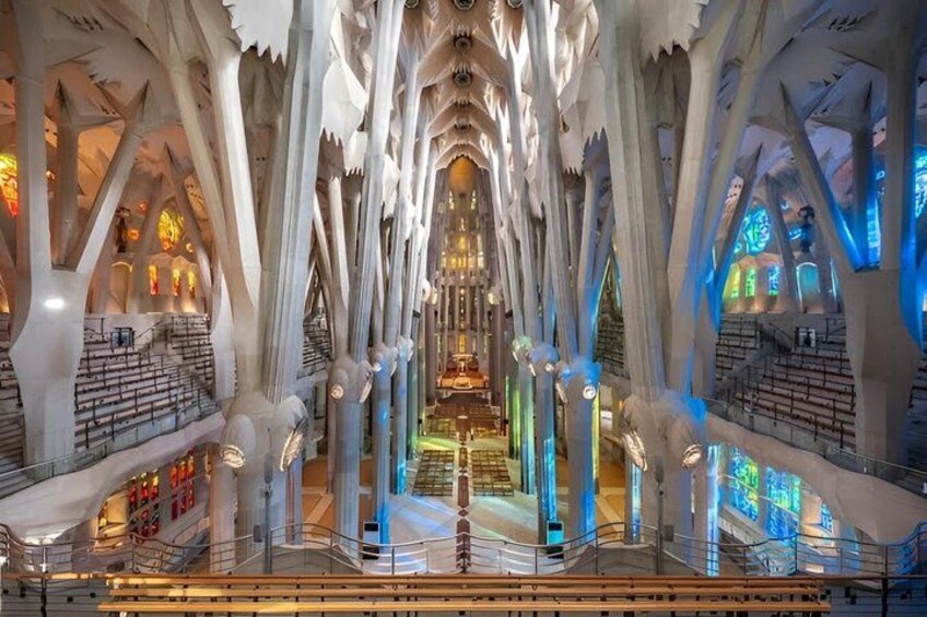 A cathedral interior with high ceilings, arched columns, and stained glass windows. 5