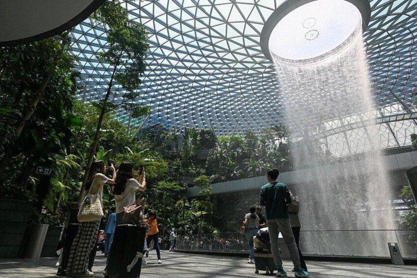 A modern architectural structure with a glass dome and a water feature. 2