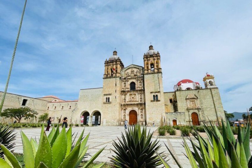 A historic church with two bell towers and a dome. 1