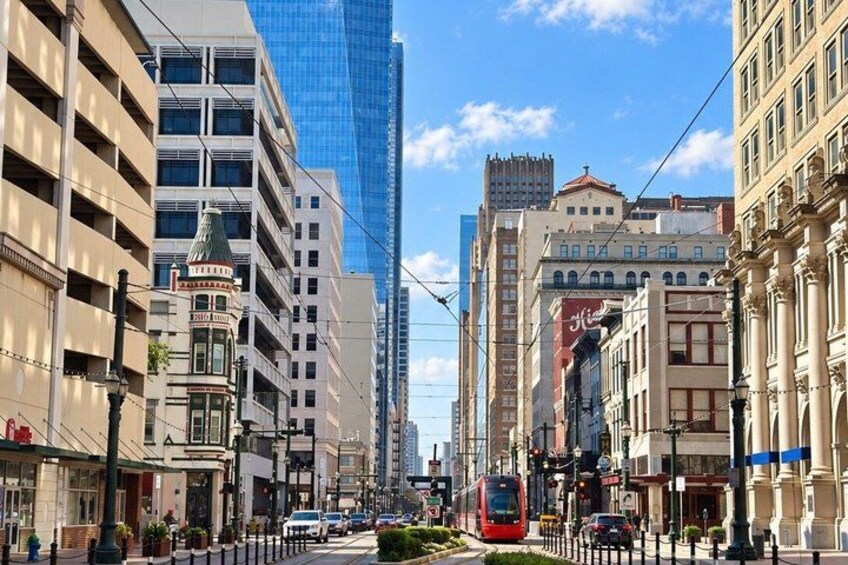 A city street with a tram, historic buildings, and modern skyscrapers. 2
