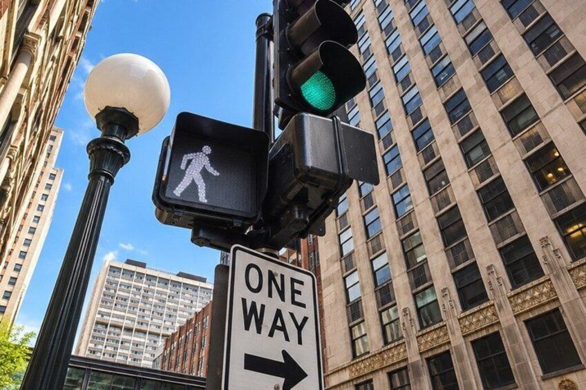 A traffic light, pedestrian crossing signal, and a one-way sign. 3