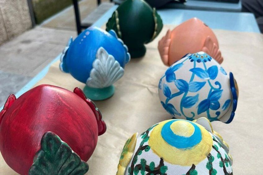 A collection of colorful ceramic eggs on a table. 5