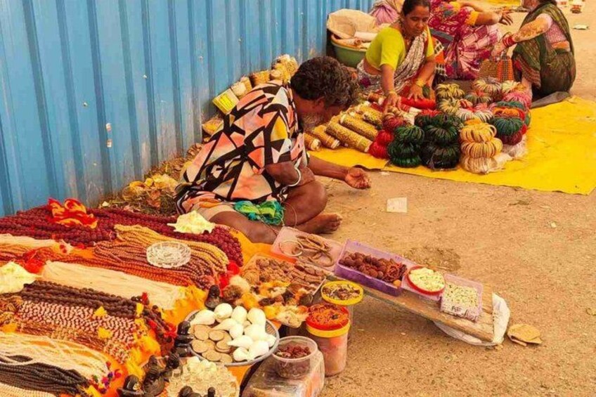 A market stall with various goods including textiles, fruits, and spices. 2