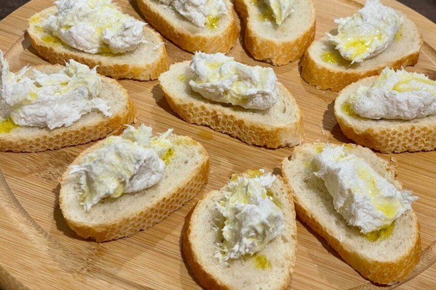 Slices of bread with a creamy spread on a wooden board. 4