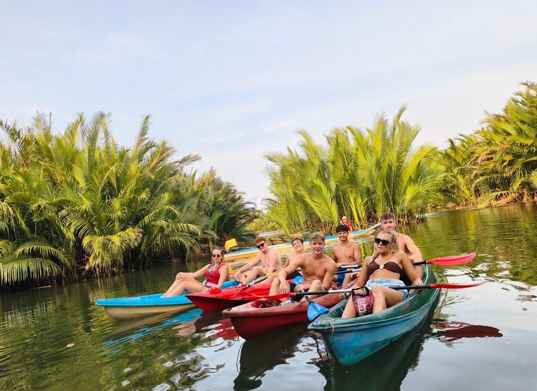 A group of people in canoes on a river surrounded by palm trees. 1