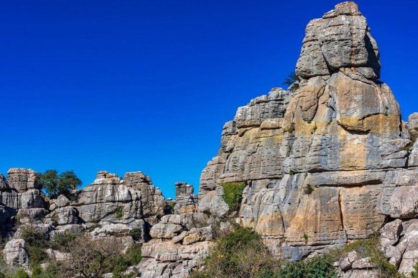 A rugged rock formation with layered sedimentary structures. 5