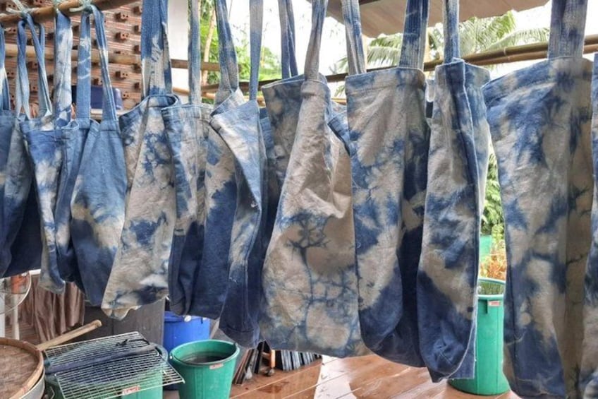 A series of denim bags hanging in a row, likely for sale. 5
