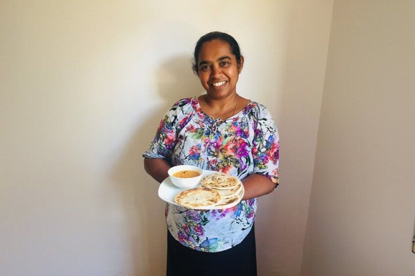 A person holding a plate with food and a bowl. 1