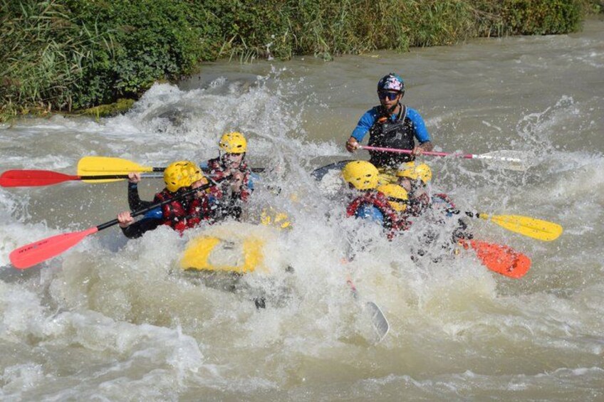 Two people kayaking in rough water. 1