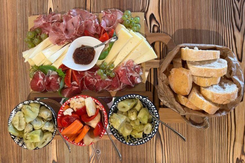 A charcuterie board with various meats, cheeses, and pickled vegetables. 3