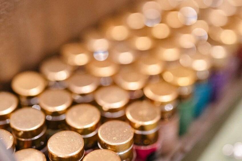 A close-up of golden cylindrical objects with reflective surfaces, likely containers or decorative items. 5