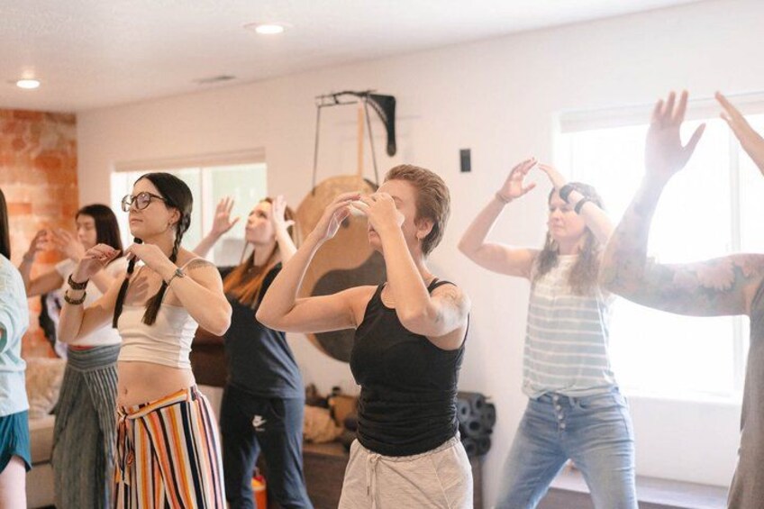 A group of people in a dance studio performing a synchronized routine. 1